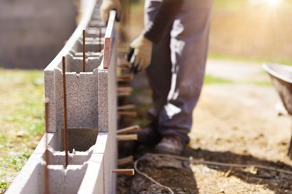 Bricklayer stacking cement blocks