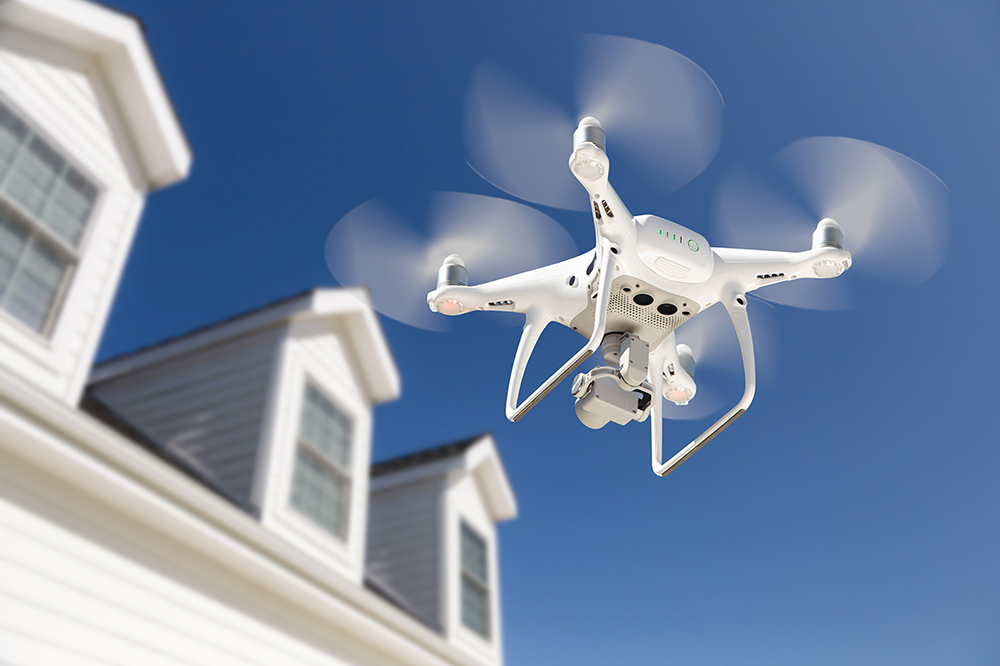 Aerial drone flying while home inspection services are being preformed